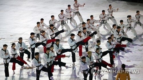 In this file photo taken Feb. 9, 2018, taekwondo demonstration teams from South and North Korea hold a joint performance during the pre-shows of the opening ceremony for the 2018 Winter Olympics at PyeongChang Olympic Stadium in PyeongChang, Gangwon Province. (Yonhap)
