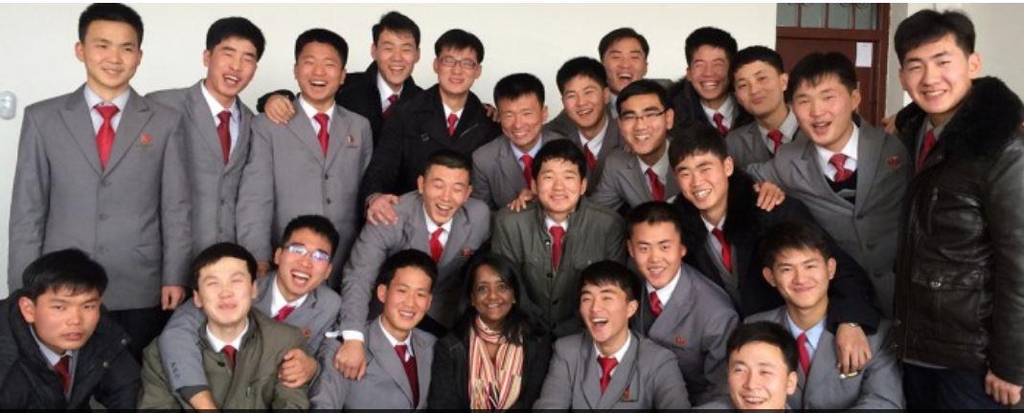 This photo captured from the website of Pyongyang University of Science & Technology on March 16, 2018, shows North Korean students posing happily with a foreign teacher. (Yonhap)