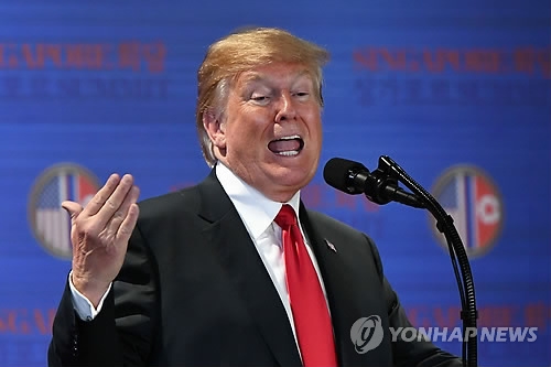 U.S. President Donald Trump speaks during a press conference in Singapore on June 12, 2018, in this photo released by AFP. (Yonhap)