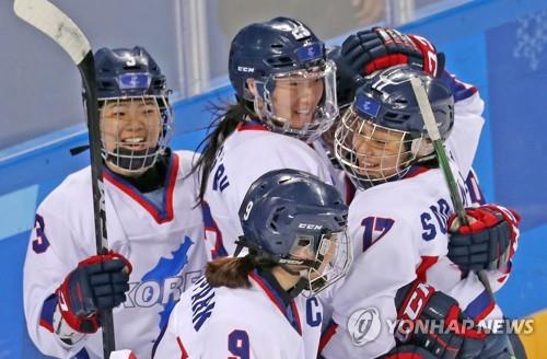 Members of the joint women's ice hockey team of the two Koreas congratulate each other in their match with Sweden at Kwandong Hockey Centre in Gangneung, around 240 kilometers east of Seoul, on Feb. 20, 2018. (Yonhap)