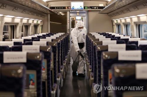 Quarantine officials disinfect a cabin of a KTX bullet train at Suseo Station in Seoul on Feb. 25, 2020, amid the spread of the new coronavirus in the country. (Yonhap)