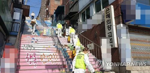 Seongnam city officials disinfect the neighborhood of River of Grace Community Church, where 40 members have tested positive for the coronavirus, on March 15, 2020, in this photo provided by Seongnam City Hall. (PHOTO NOT FOR SALE) (Yonhap)