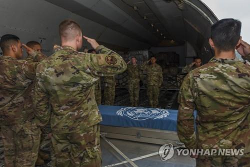 Members of the United Nations Command (UNC) salute caskets containing the remains of UNC service members killed during the 1950-53 Korean War during a ceremony at Osan Air Base in Pyeongtaek, Gyeonggi Province, on June 26, 2020, in this photo provided by the air base. The remains were transferred to the Defense POW/MIA Accounting Agency at Joint Base Pearl Harbor-Hickam, Hawaii. (PHOTO NOT FOR SALE) (Yonhap)