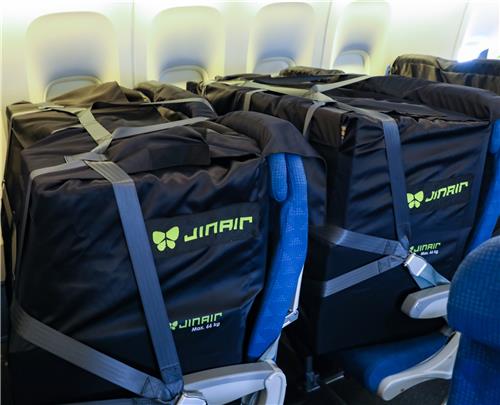 This undated file photo provided by Jin Air shows cargo in cargo seat bags attached to seats of a converted B777-200ER plane. (Yonhap)