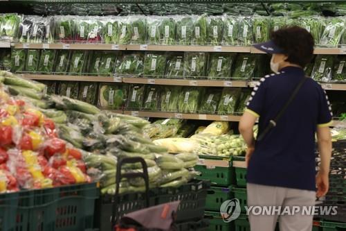 A woman shops for groceries at a discount chain store in Seoul on July 4, 2022, amid high inflation. (Yonhap)