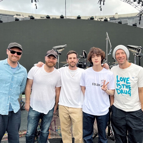 BTS' Jin (2nd from R) and British rock band Coldplay pose for the camera during a rehearsal for their joint performance of "The Astronaut" at Coldplay's concert in Buenos Aires, Argentina, on Oct. 28, 2022. This photo was captured from the British band's Twitter page. (PHOTO NOT FOR SALE) (Yonhap)
