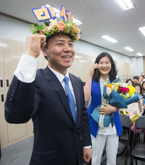 승리의 월계관을 쓰고 화이팅 하는 김승수 당선인