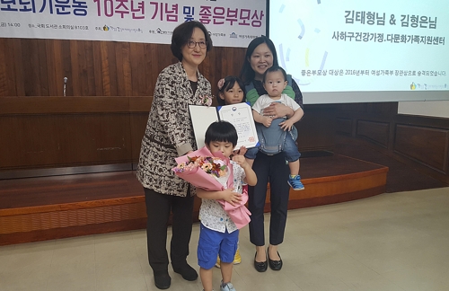 (서울=연합뉴스) 이희용 기자 = 이정심 여성가족부 가족정책관이 진선미 여성가족부 장관을 대신해 김형은 씨에게 좋은부모상 대상을 시상한 뒤 수상자 가족과 기념촬영을 하고 있다.