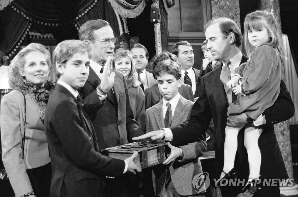 1985년 상원의원 선서하는 바이든 대통령. 품에 딸 애슐리를 안고 있고 아들 헌터와 보가 성경을 들고 있다.