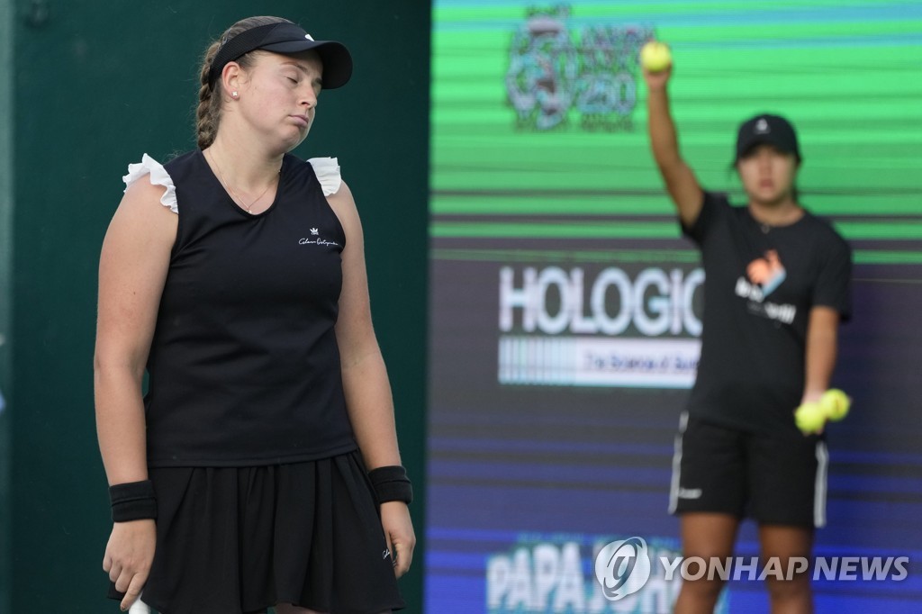 In this Associated Press photo, Jelena Ostapenko of Latvia reacts after missing a shot against Jeong Bo-young of South Korea during their women's singles round of 32 match at the WTA Hana Bank Korea Open at Olympic Park Tennis Center in Seoul on Sept. 20, 2022. (Yonhap)