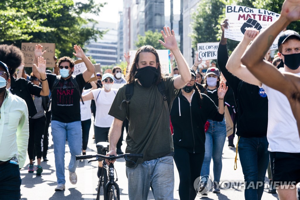 여러 인종이 뒤섞여 행진하는 미국 워싱턴의 인종차별 반대 집회