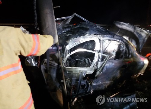 전봇대와 충돌하고 전소한 승용차