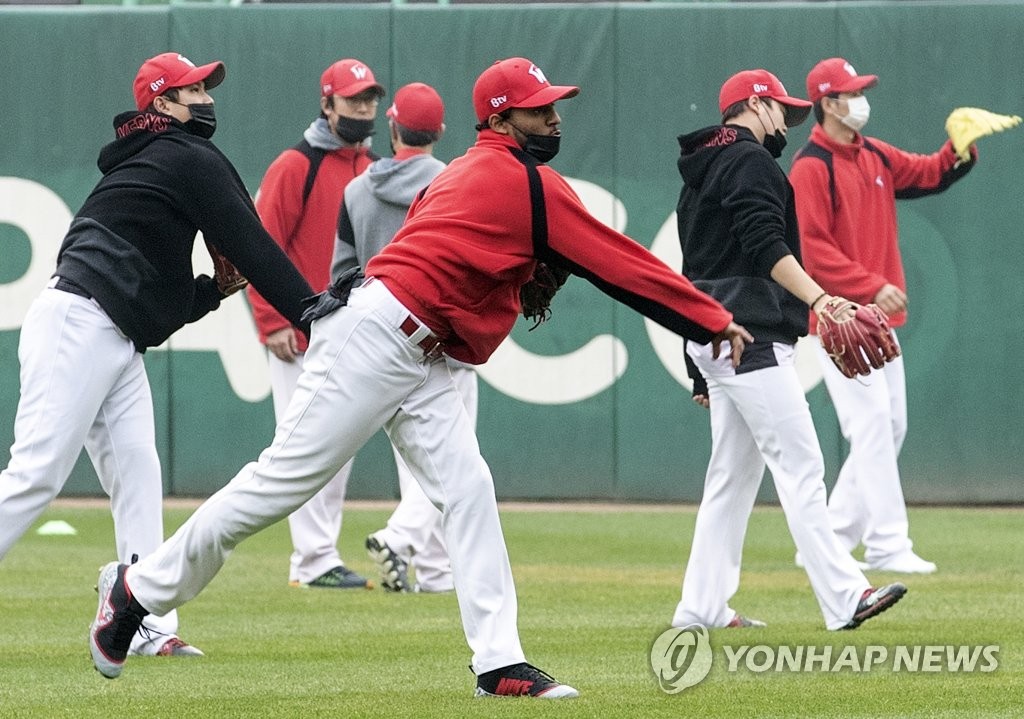 In this file photo from Nov. 7, 2018, players of the SK Wyverns practice for Game 3 of the Korean Series against the Doosan Bears while wearing masks in dusty conditions at SK Happy Dream Park in Incheon, 40 kilometers west of Seoul. (Yonhap)