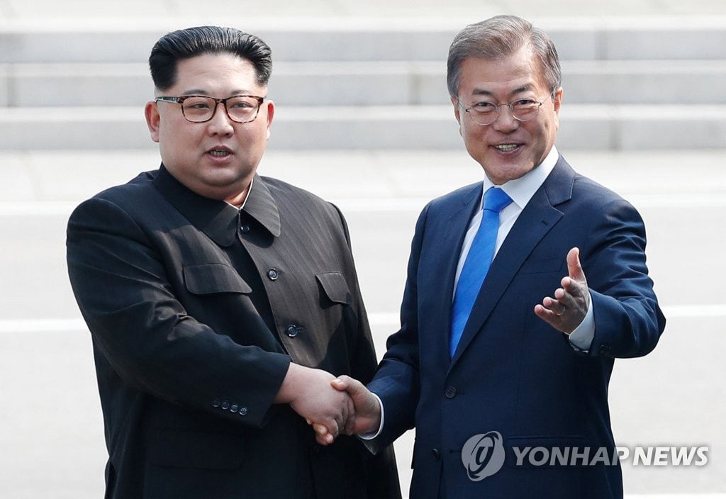 This file photo, taken April 27, 2018, shows President Moon Jae-in (R) shaking hands with North Korean leader Kim Jong-un before their summit at the inter-Korean border village of Panmunjom. (Yonhap)