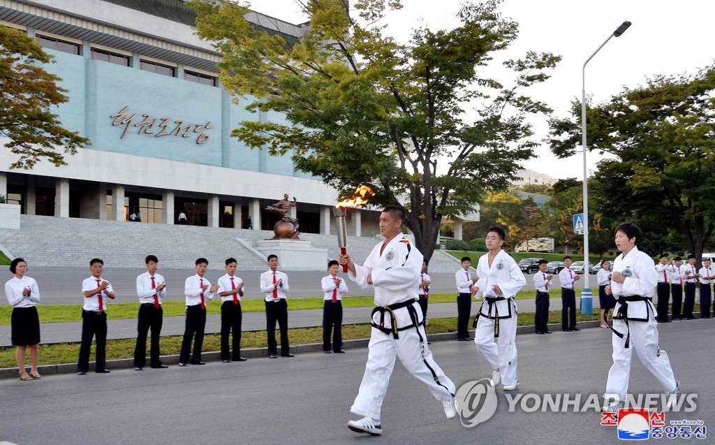 Torch ignited in N. Korea for martial arts competition Torch ignited in N. Korea for martial arts competition
