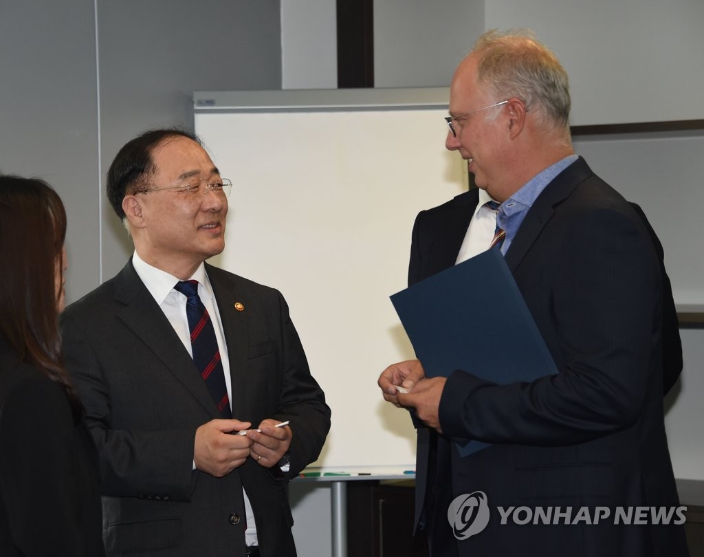 South Korean Finance Minister Hong Nam-ki (L) talks with Kirill Dmitriev, the head of the Russia Direct Investment Fund, in Moscow on Sept. 26, 2019, in this photo released by the Ministry of Economy and Finance. (PHOTO NOT FOR SALE)(Yonhap)
