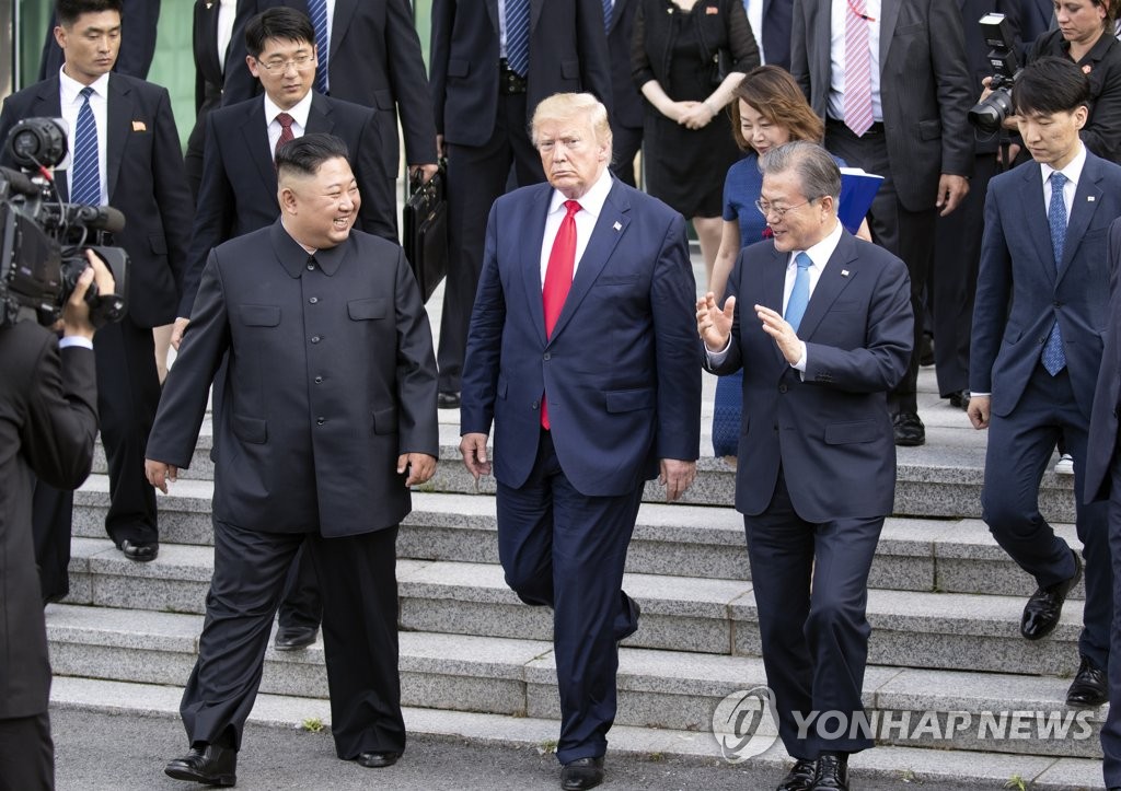 This June 30, 2019, file photo shows then South Korean President Moon Jae-in (R) and his U.S. and North Korean counterparts, Donald Trump (C) and Kim Jong-un, at the inter-Korean truce village of Panmunjom. (Yonhap)