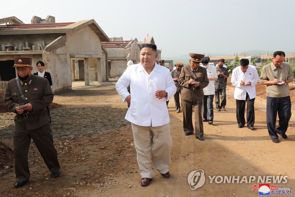 North Korean leader Kim Jong-un (C) inspects the construction site of a chicken farm in Kwangchon-ri, Hwangju, North Hwanghae Province, in this undated photo provided by the Korean Central News Agency on July 23, 2020. (For Use Only in the Republic of Korea. No Redistribution) (Yonhap)