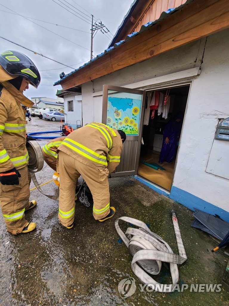 Firefighters drain flood water Firefighters drain flood water