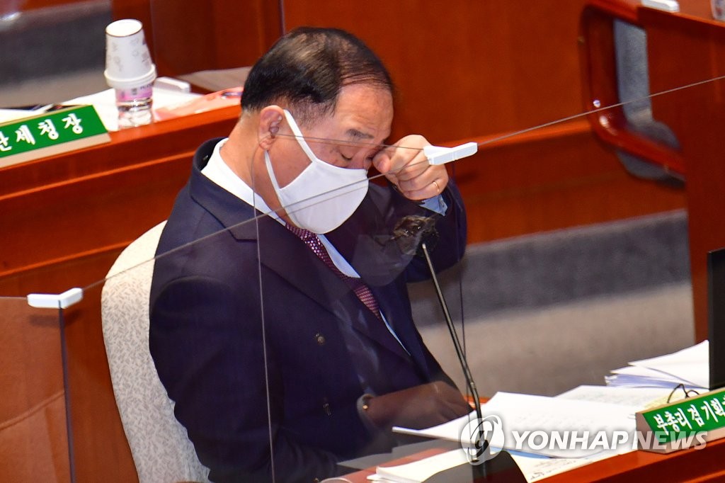 눈 만지는 홍남기 경제부총리