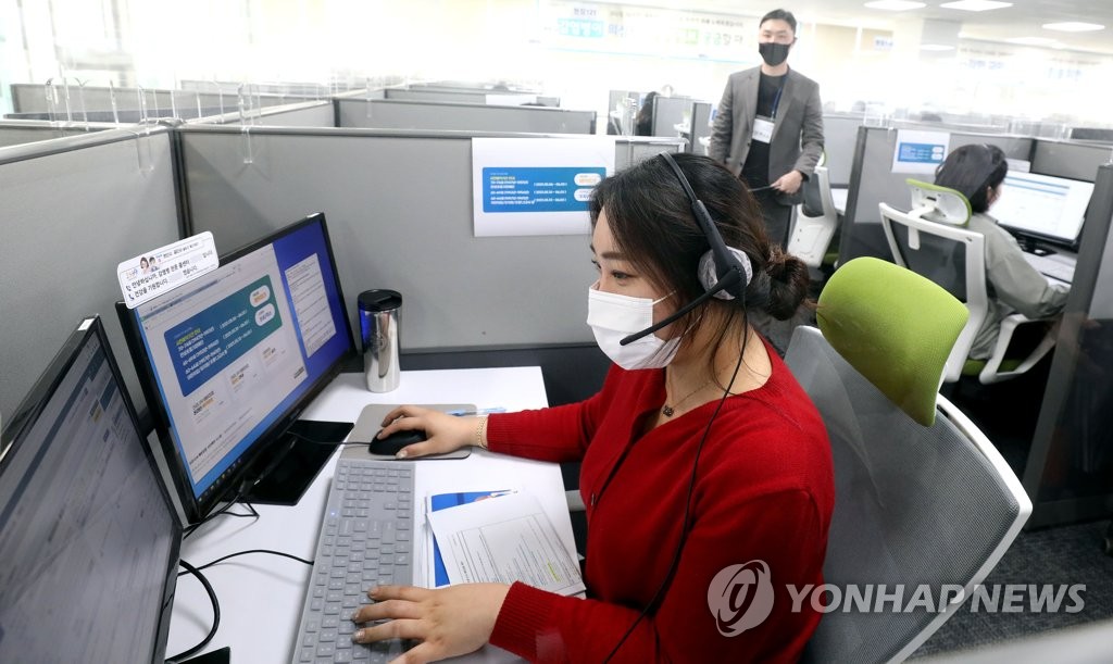 A worker takes a call from someone applying for a coronavirus vaccination for an elderly person aged 70 or older at a 1339 call center in Seoul. (Yonhap)
