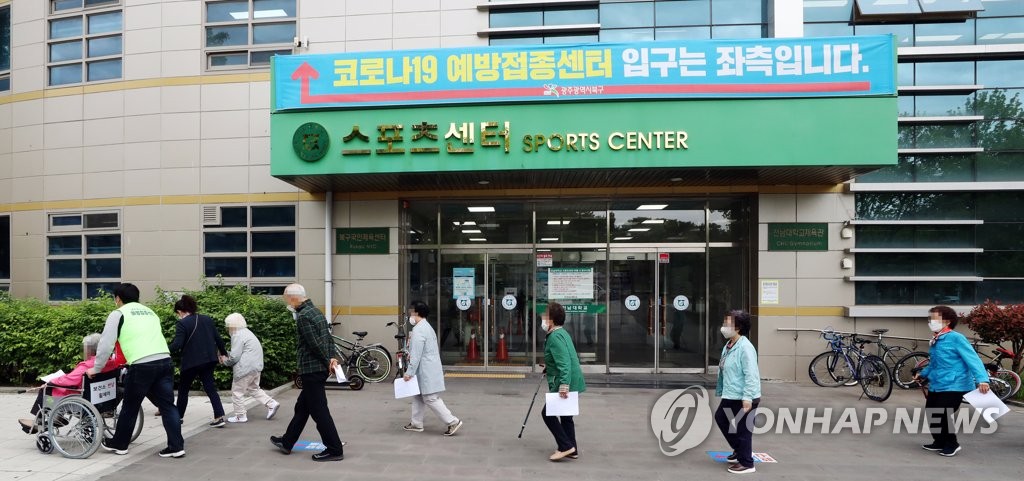 This photo taken May 10, 2021, shows elderly people walking into a coronavirus vaccination facility in Gwangju, 330 kilometers southwest of Seoul. (Yonhap)