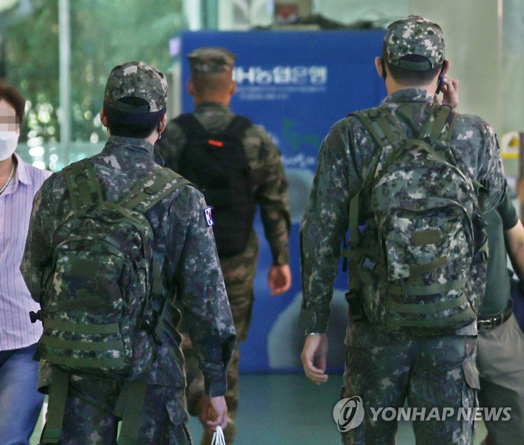 In this file photo taken Oct. 3, 2021, soldiers walk at a bus terminal in eastern Seoul. (Yonhap)