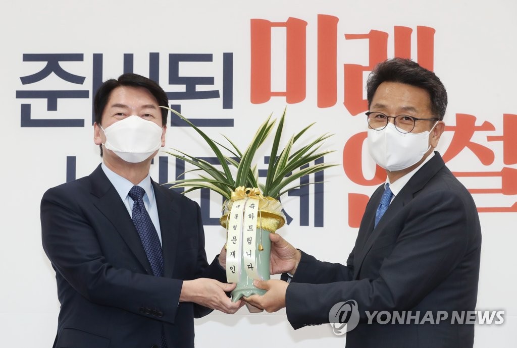 문재인 대통령의 축하 난을 전달받는 안철수 후보