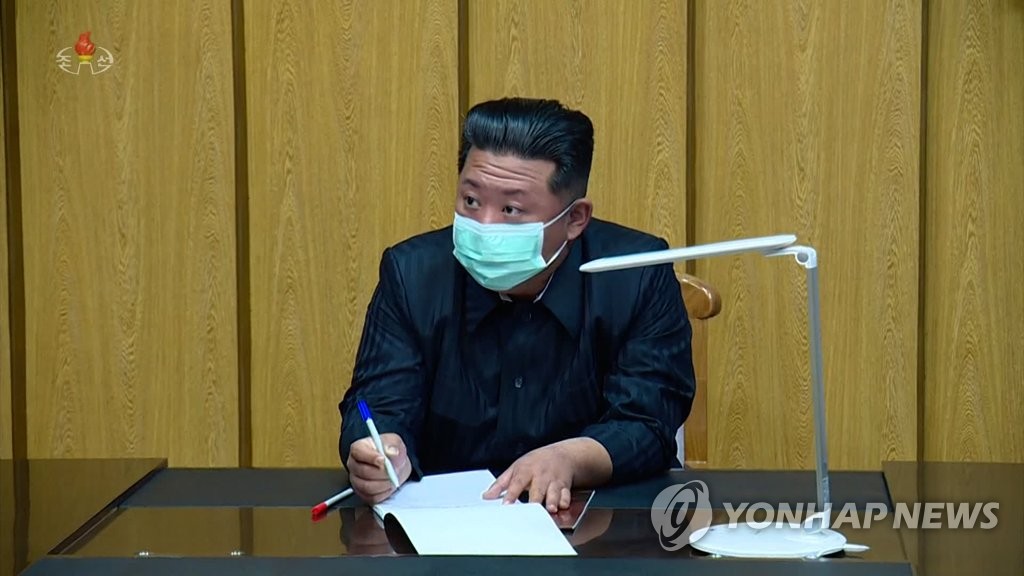 North Korean leader Kim Jong-un, wearing a mask, receives a report while visiting the State Emergency Epidemic Prevention Headquarters in Pyongyang on May 12, 2022, in this photo captured from the North's Korean Central TV. On May 13, the North said that six people have died from COVID-19 and that around 18,000 people newly showed symptoms of a fever the previous day. (For Use Only in the Republic of Korea. No Redistribution) (Yonhap)