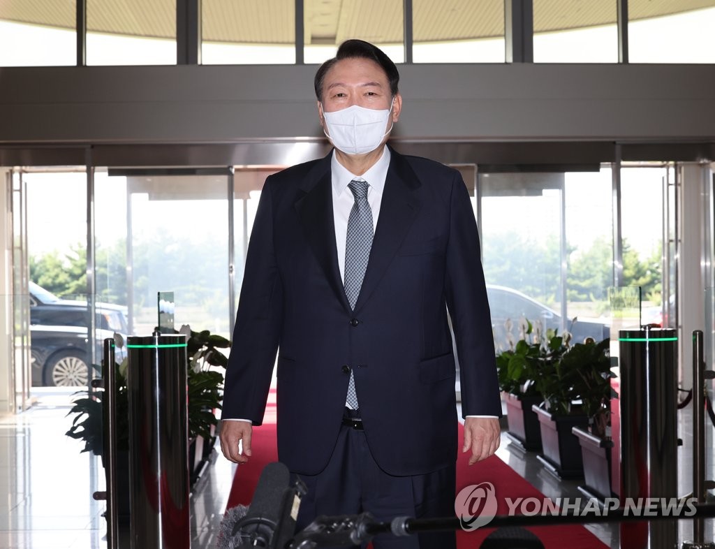 President Yoon Suk-yeol responds to questions from reporters as he arrives for work at the presidential office in Seoul on July 25, 2022. (Yonhap)