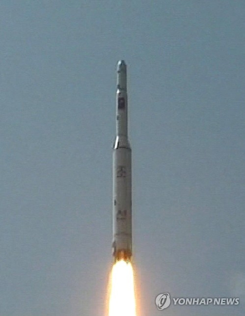 This undated file photo shows a rocket being fired from a launch site in North Korea. (Yonhap)