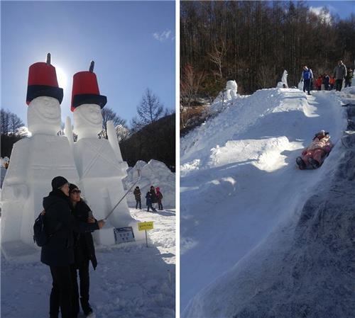 Travelers enjoy the Mount Taebaek Snow Festival, taking a selfie or sledding on Jan. 16, 2017. (Yonhap)
