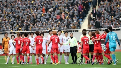 The players of the South Korean and North Korean women's national football teams shake hands after their Asian Football Confederation Women's Asian Cup Group B qualifying match at Kim Il-sung Stadium in Pyongyang on April 7, 2017. (Joint Press Corps)
