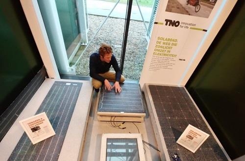 Stan Klerks, lead engineer of the SolaRoad project, examines a prototype solar module at a TNO office in Delft, Netherlands. (Yonhap)