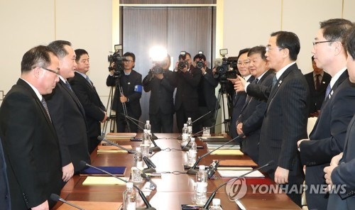 This photo, taken by the Joint Press Corps on Jan. 9, 2018, shows negotiators from South Korea (R) and North Korea after high-level talks at the border truce village of Panmunjom. (Yonhap)