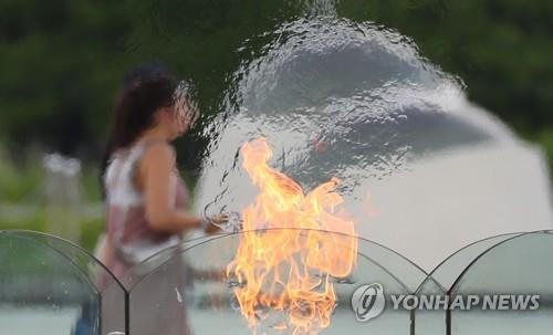 This file photo taken in August 2019 shows a Seoul citizen walking in a public park in southern Seoul. (Yonhap)