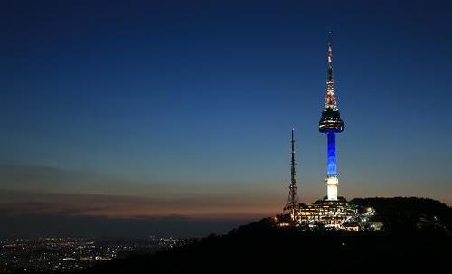 N Seoul Tower is lit up with blue light in this photo provided by Seoul City Hall on April 16, 2020. (PHOTO NOT FOR SALE) (Yonhap)
