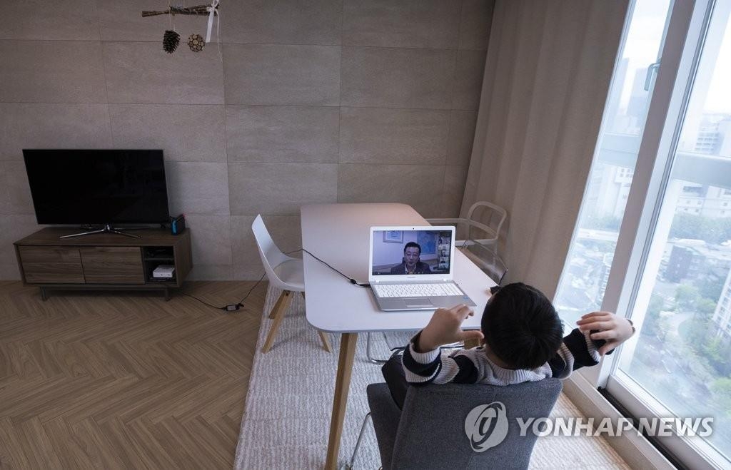 The undated file photo shows a kid studying at home. (Yonhap)