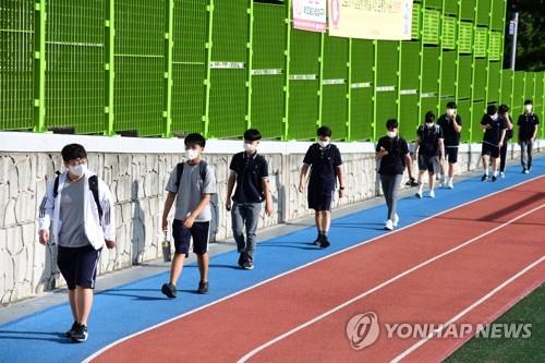 This photo provided by the education office in Jeju, an island off the southern coast of South Korea, shows middle school students on their way to school while social distancing on Aug. 2, 2021. (PHOTO NOT FOR SALE) (Yonhap) 