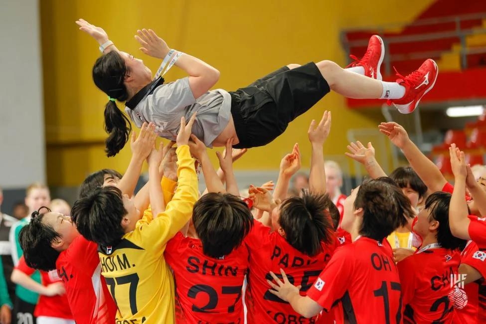 South Korean players toss their head coach Kim Jin-soon in the air after winning the gold medal at the International Handball Federation (IHF) Women's Youth World Championship at Boris Trajkovski Sports Center in Skopje, North Macedonia, on Aug. 10, 2022, in this photo provided by the IHF. (PHOTO NOT FOR SALE) (Yonhap)