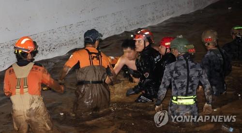 A man who went missing in the inundated underground parking lot of an apartment building in the southeastern city of Pohang is rescued on Sept. 6, 2022. (Yonhap) 