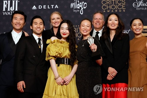 In this AFP photo, the cast of "Pachinko" poses for the camera after the TV series won the best foreign language series at the 28th annual Critics Choice Awards in Los Angeles on Jan. 15, 2023. (Yonhap)