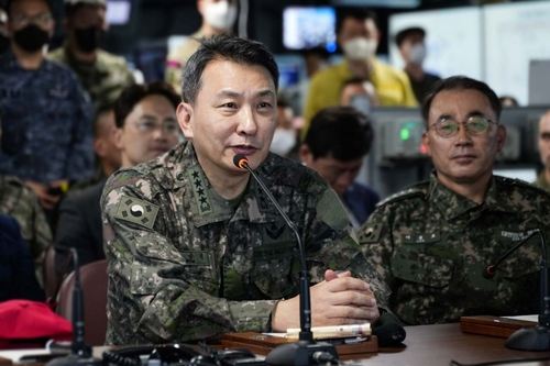 Joint Chiefs of Staff Chairman Gen. Kim Seung-kyum (L) speaks during a visit to the South Korean Navy's ROKS Marado amphibious landing ship on March 29, 2023, in this photo released by his office. (PHOTO NOT FOR SALE) (Yonhap)