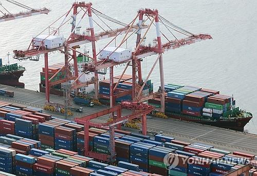 Shipping containers are stacked at a pier in South Korea&apos;s largest port city of Busan on Jan. 1, 2024. (Yonhap)