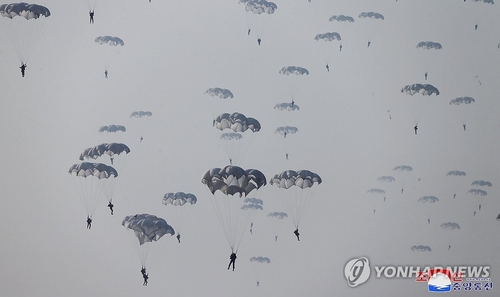 This photo, carried by North Korea's official Korean Central News Agency on March 16, 2024, shows the North staging military drills of paratroopers, guided by its leader Kim Jong-un, the previous day. (For Use Only in the Republic of Korea. No Redistribution) (Yonhap)