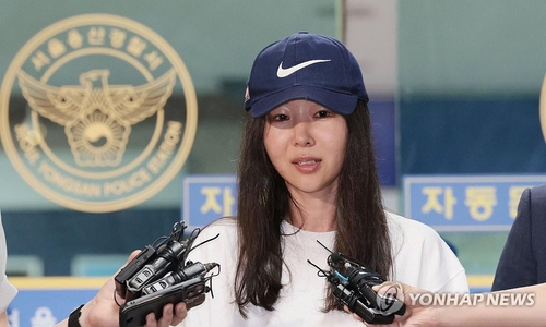 This file photo taken July 9, 2024, shows ADOR CEO Min Hee-jin stepping out of a police station in Yongsan, Seoul, after an investigation of breach of duty charges against her. (Yonhap)