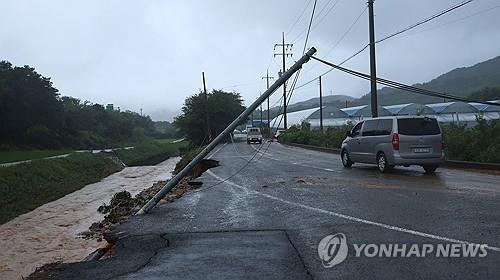 A telephone pole leans above a road in the southern county of Sancheong on July 19, 2025, after heavy rains struck the area. (Yonhap)