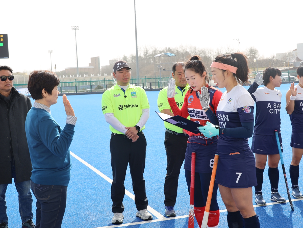 Players of the women’s general division team taking the clean hockey oath before the start of the game.