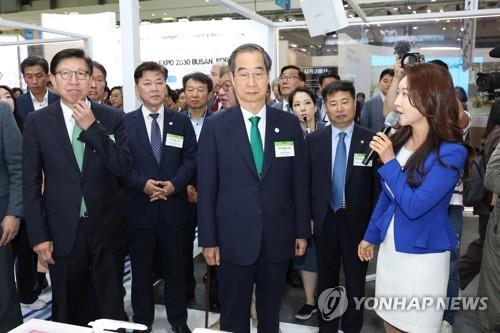 El primer ministro, Han Duck-soo (centro), asiste, el 25 de mayo de 2023, a la Expo Mundial de la Industria Climática, celebrada en la ciudad portuaria de Busan, en el sureste de Seúl. 