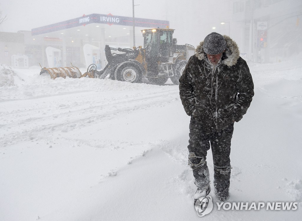눈폭풍이 몰아친 세이튼존스 시가지를 걷는 한 보행자